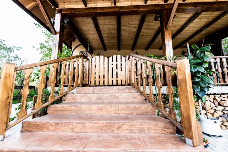 Wooden stairs leading up to the terrace of the house