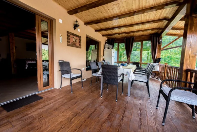 The covered wooden terrace of the main house